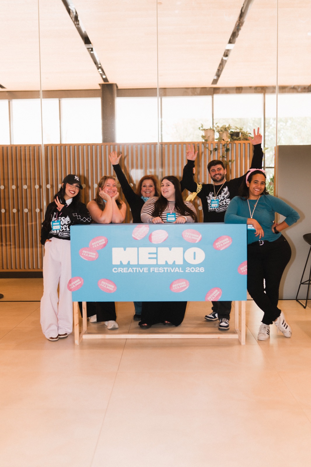 A group poses behind the Memo Creative Festival 2026 sign.